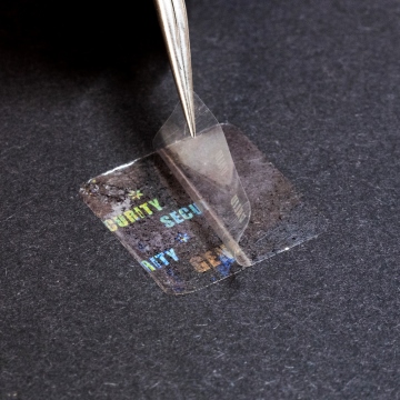 Transparent sealing film with a hidden hologram labels 20x20 mm